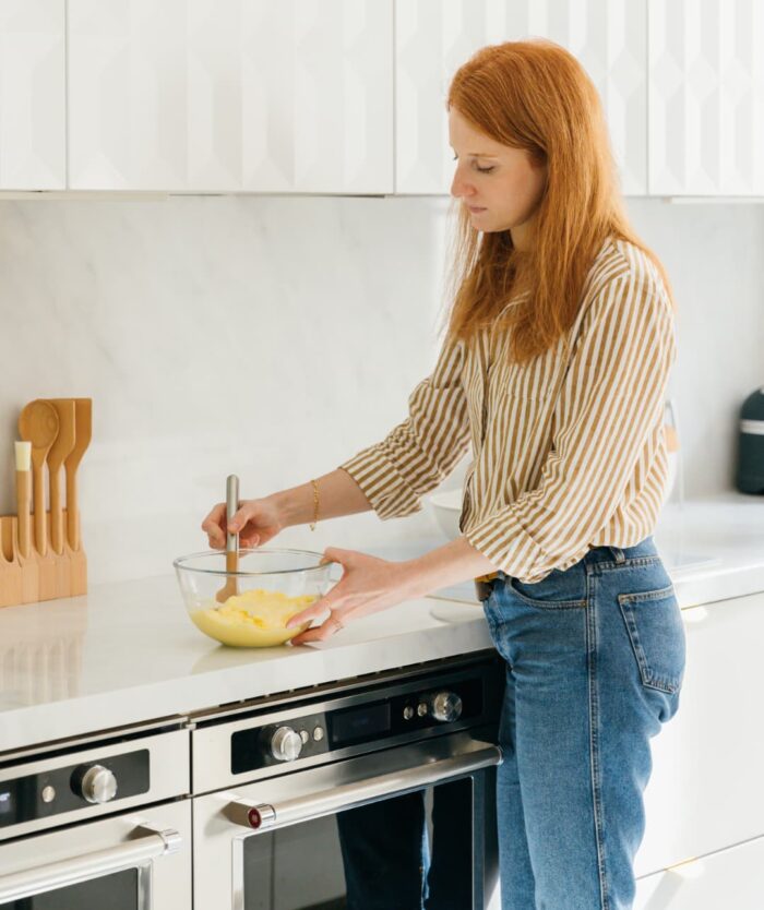 Femme préparant une crème avec La Maryse Consciencieuse de Casavida dans sa cuisine
